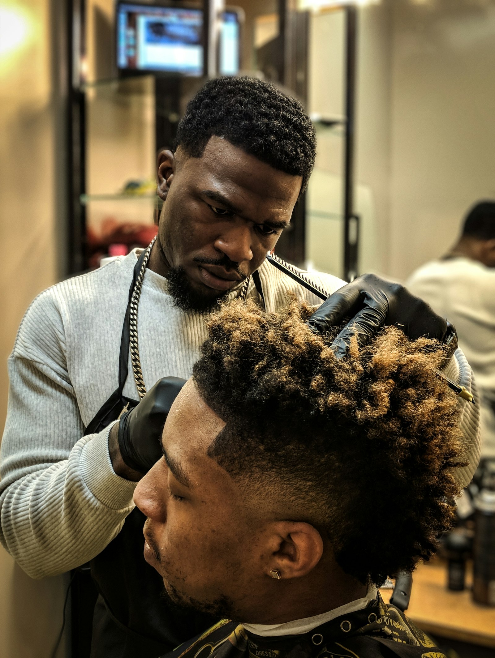 Client getting a fade at the mirror wall